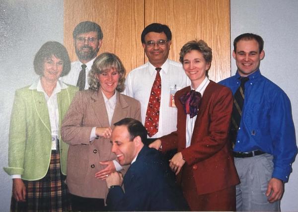 Sheilha Gallant-Halloran with the professional team she managed at the regulator — actuaries and accountants whose entire job was catching risk before it became a headline. Nobody outside that room saw this work either.